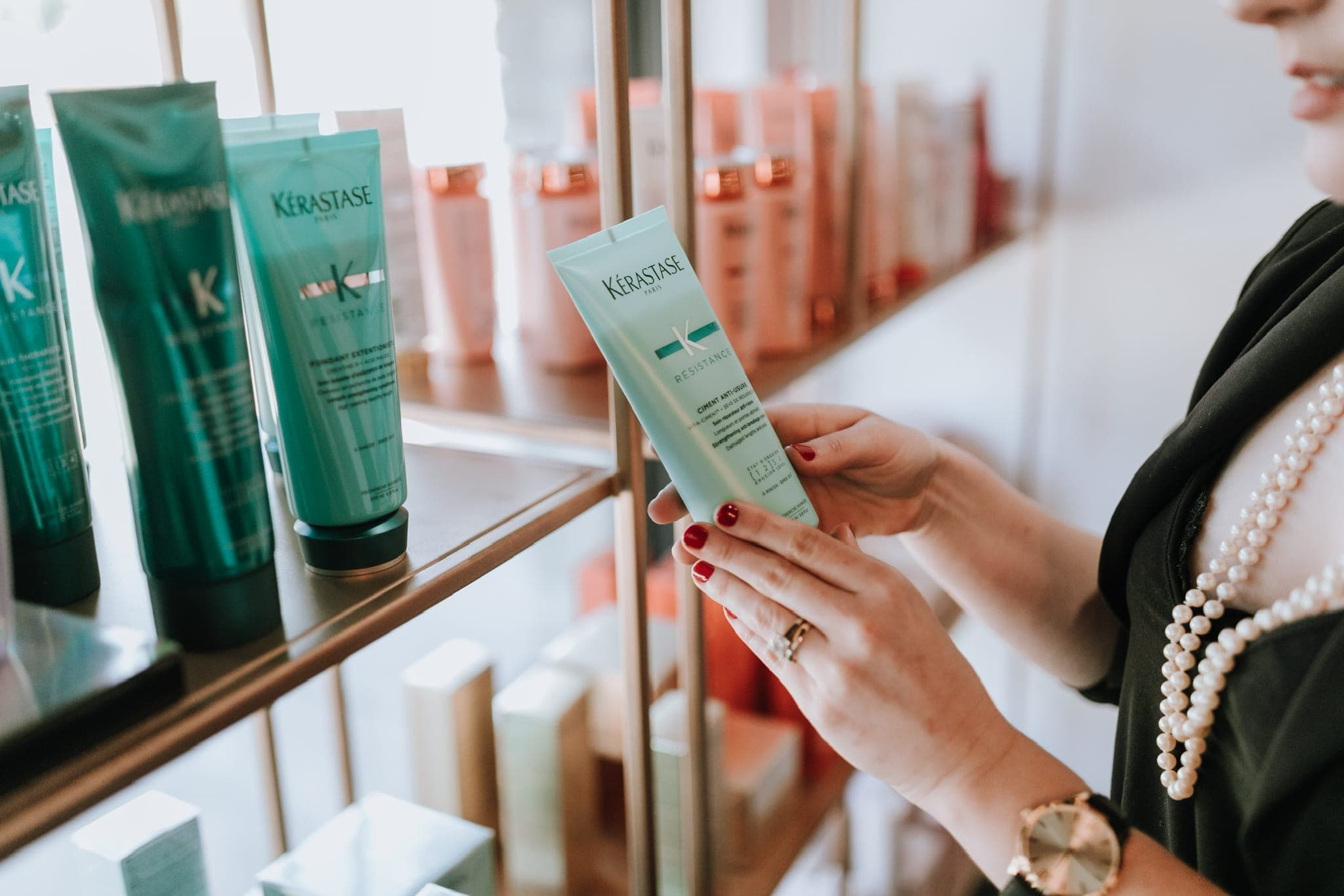 Kérastase products on the gold retail shelving at Lustre of Pearl