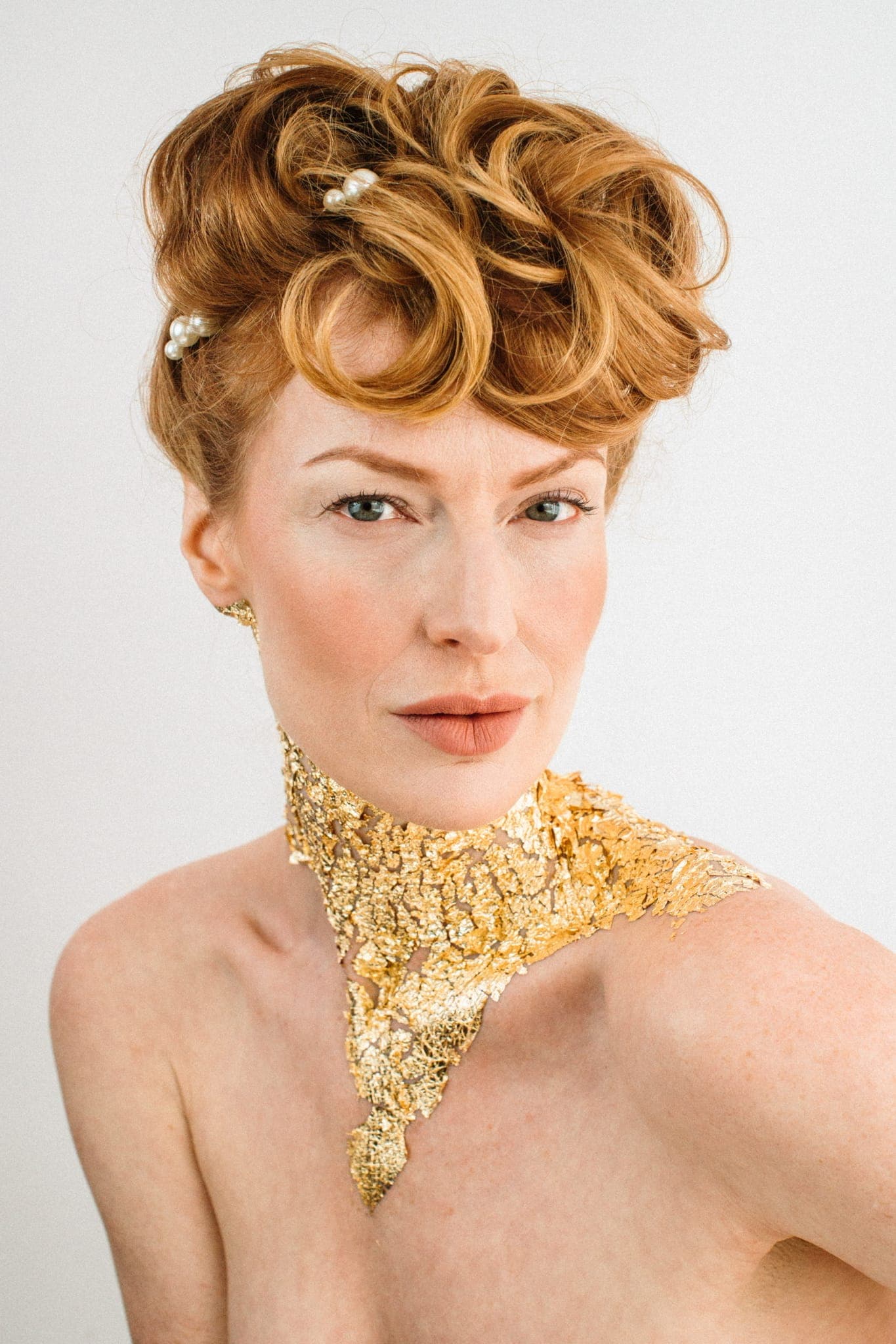 Editorial bridal updo with gold-leaf accents