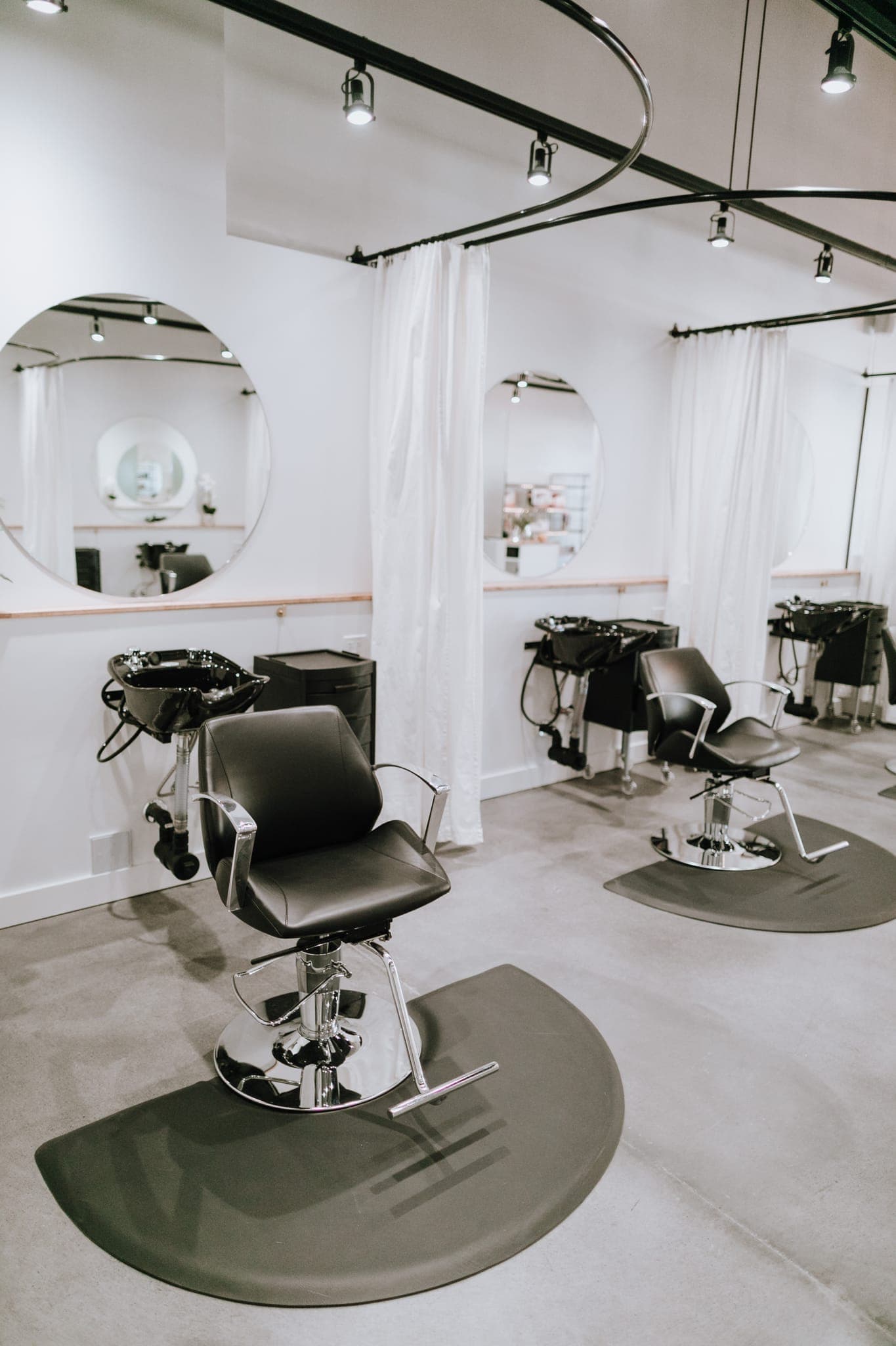 Angled view of the salon styling and wash stations