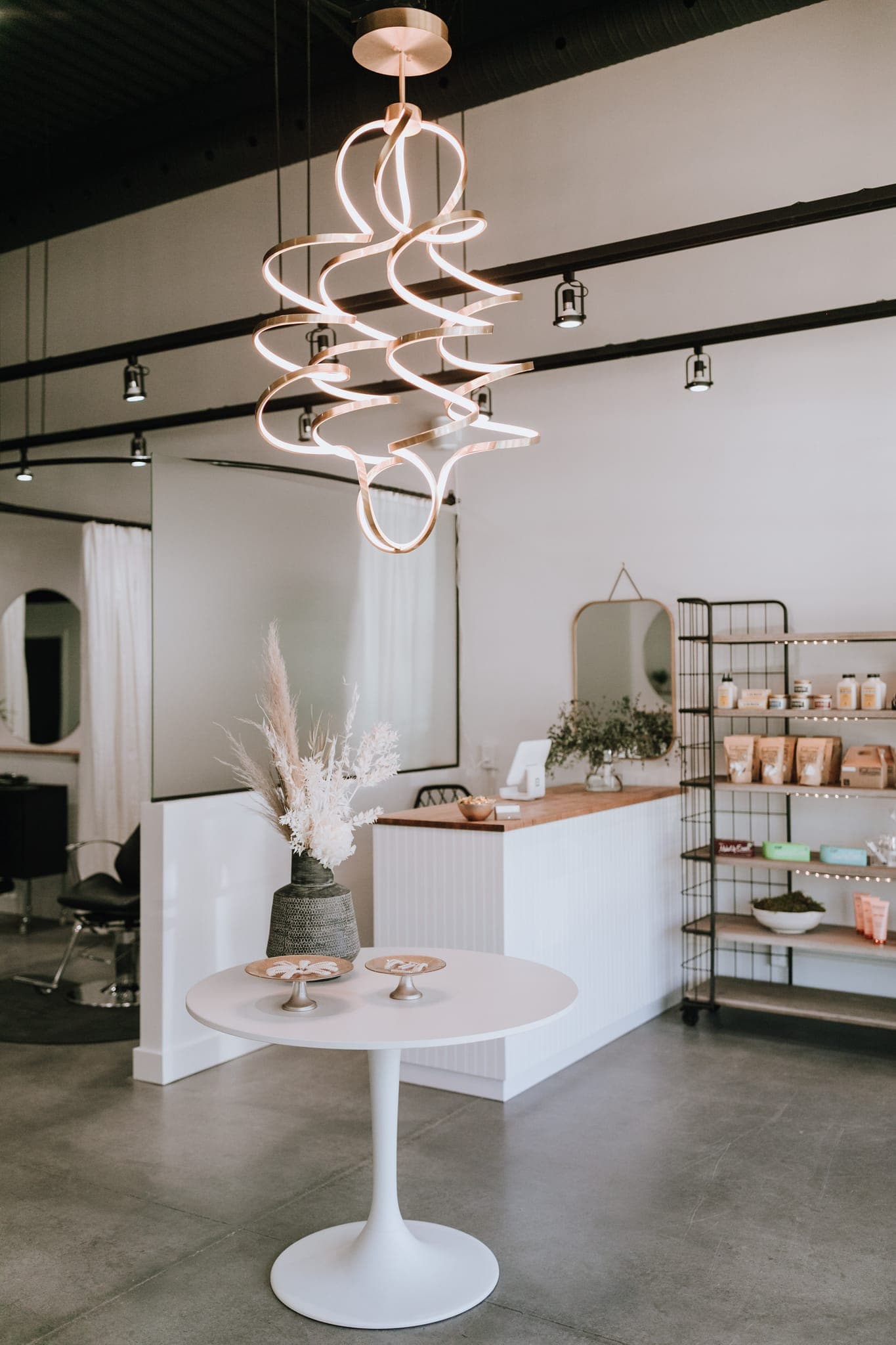 Reception and retail area with the sculptural swirl light fixture