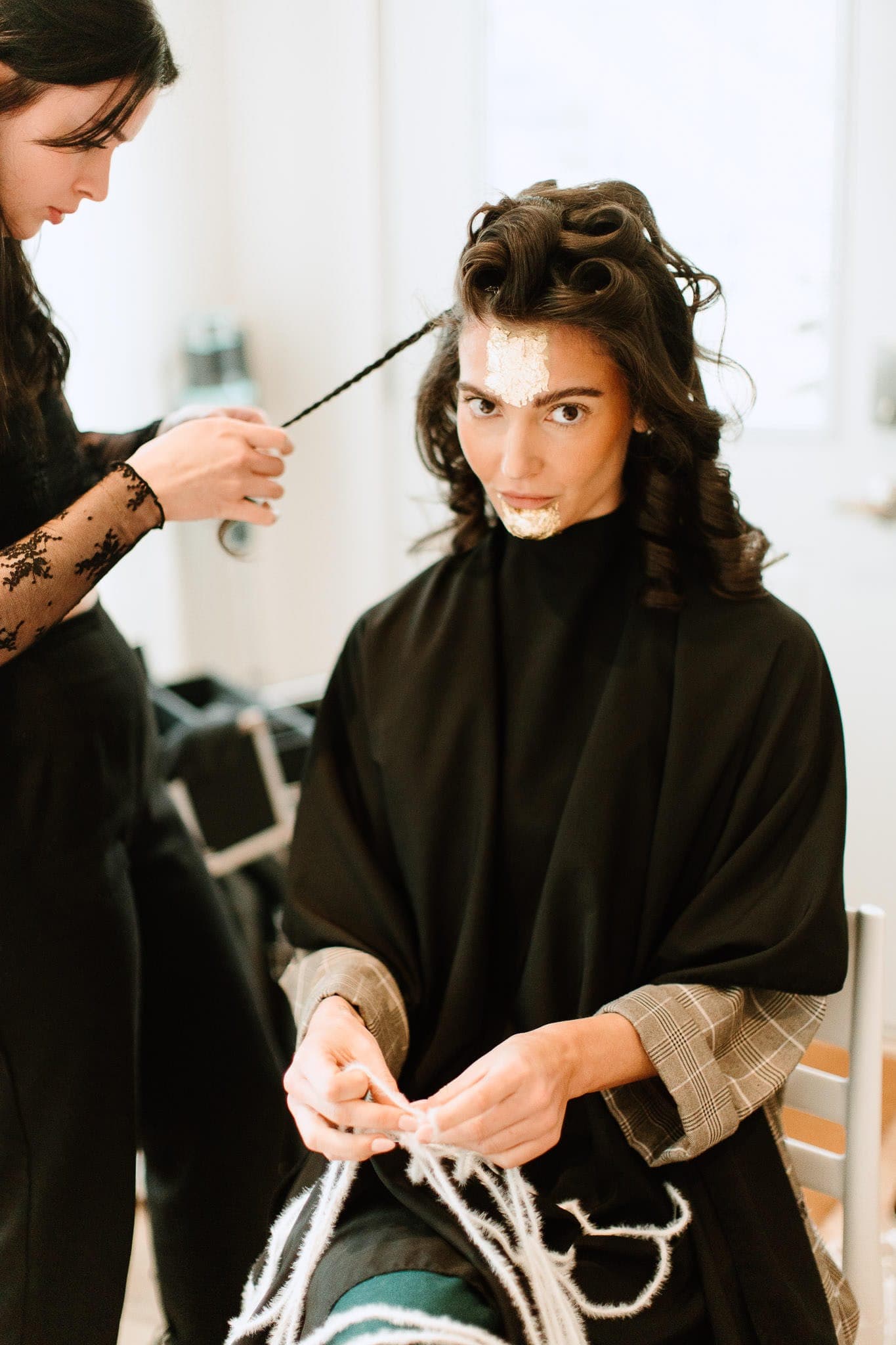 Client in pin curls and rollers during a styling service