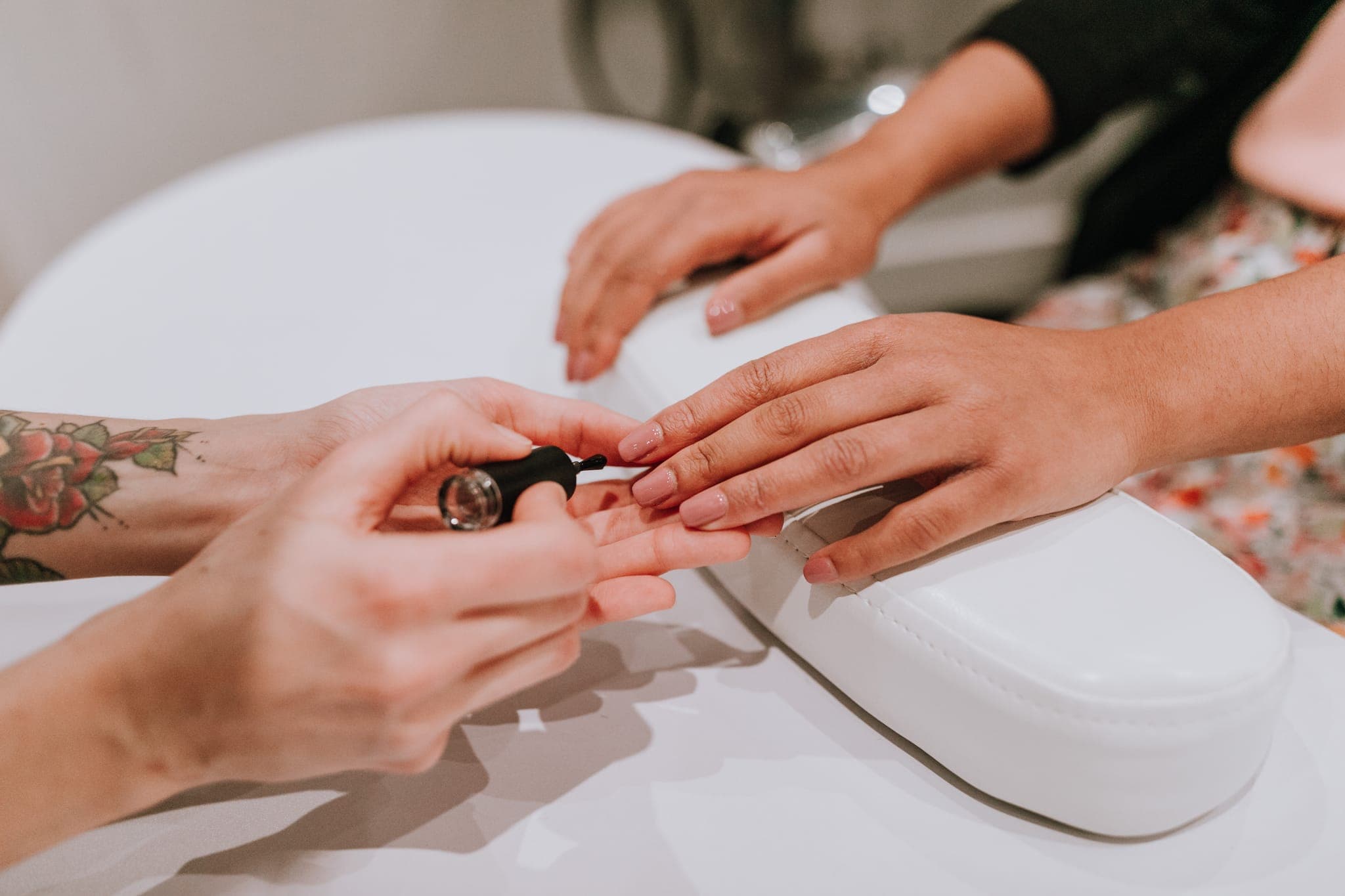 Natural nails being painted at the nail station